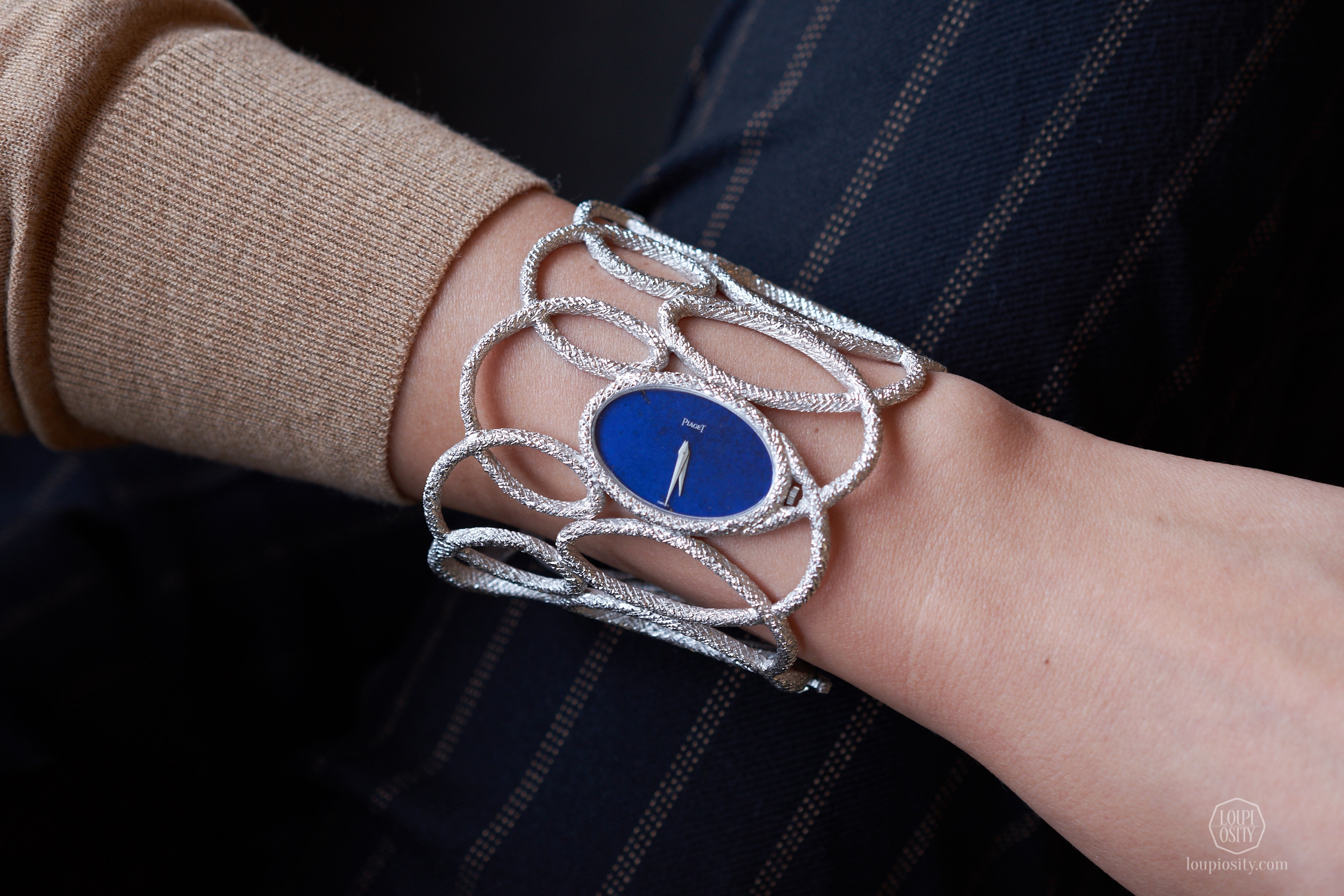 Lots 237 Piaget Manchette white gold openwork textured bangle watch with lapis lazuli dial