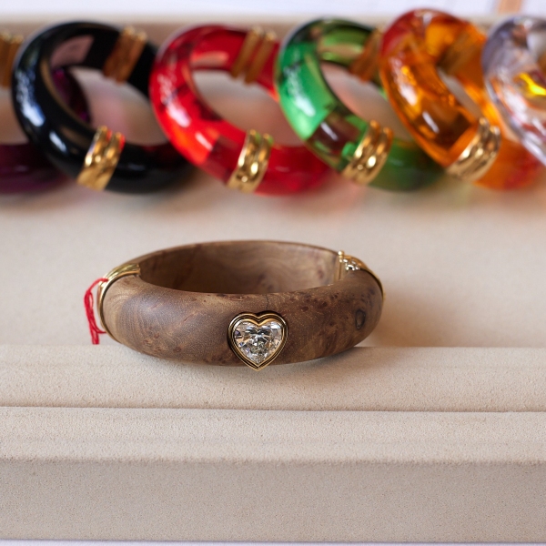 A wood bangle set (lot 338) with heart-shaped diamond
