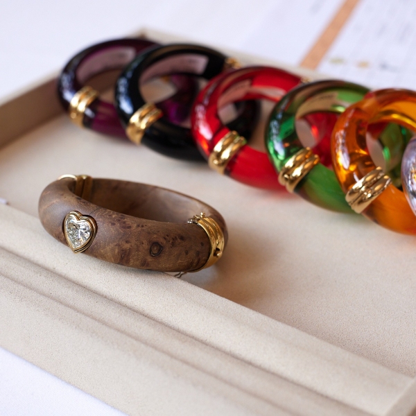 A wood bangle set (lot 338) with heart-shaped diamond